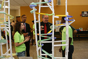 Students show Superintendent Woods a STEM project